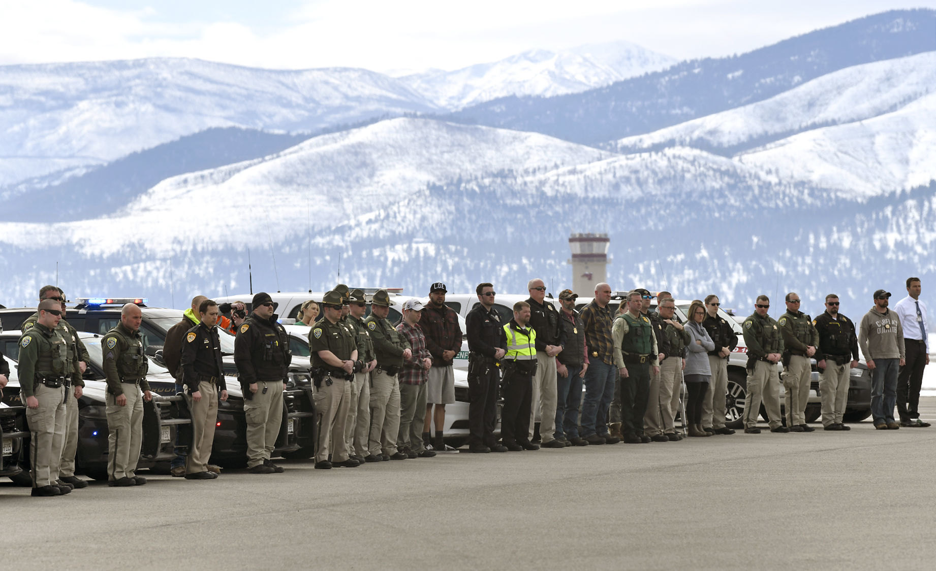 Officers line the tarmac